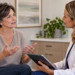 Middle-aged woman discussing her symptoms and health concerns with a female healthcare provider during a personalized hormone replacement therapy consultation.
