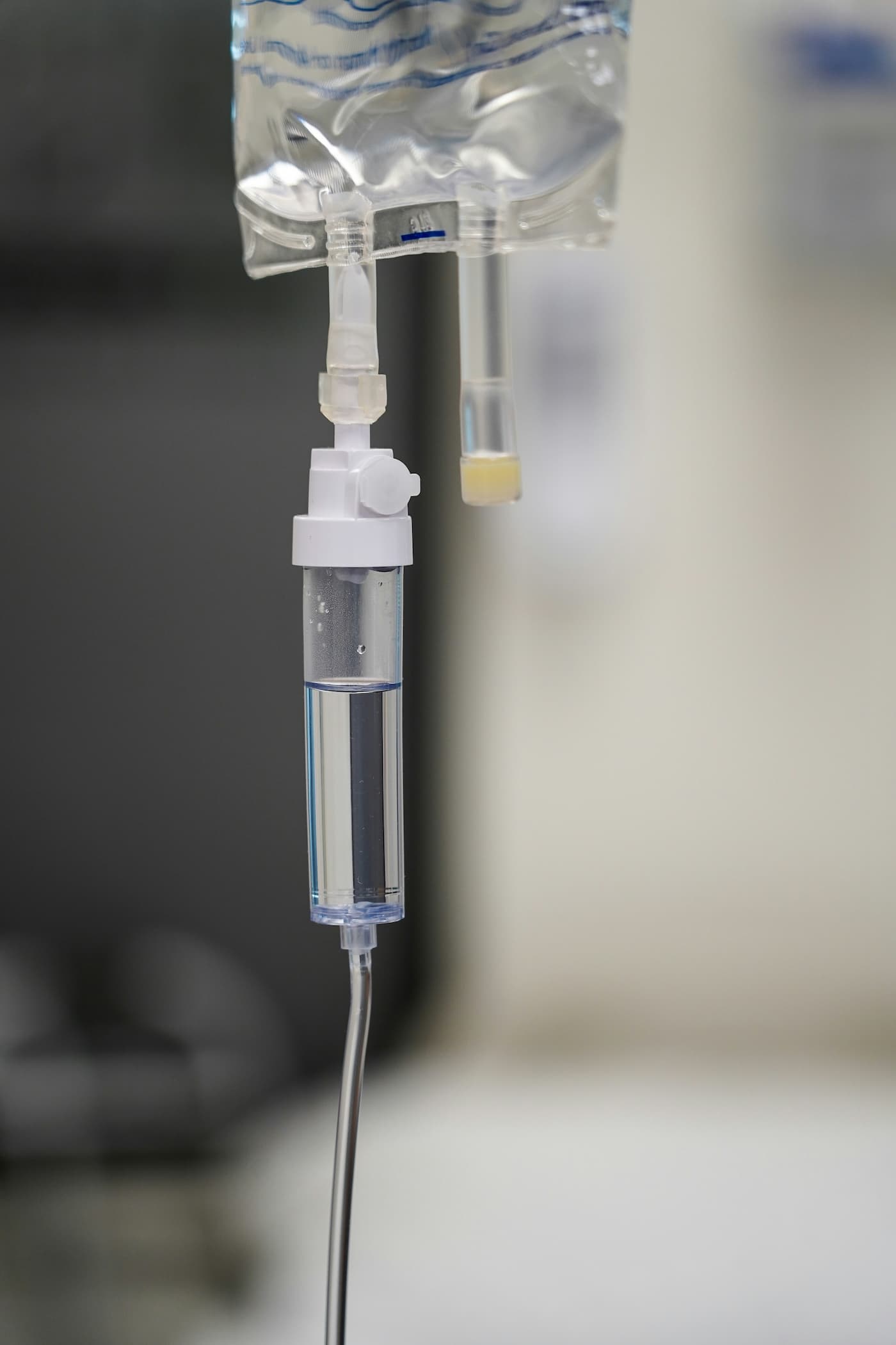 Close-up of an intravenous (IV) drip chamber containing clear fluid, representing IV hydration and wellness therapy at Vital Glow in Columbia, SC.