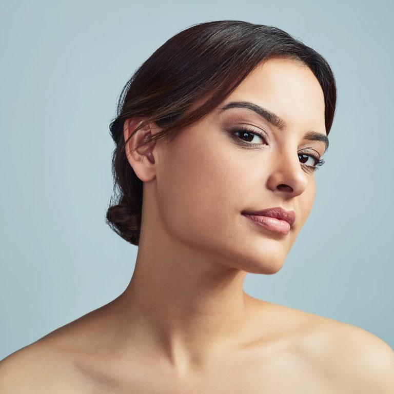 Portrait of a brunette woman with smooth, healthy-looking skin and minimal makeup, highlighting natural beauty and an even complexion.